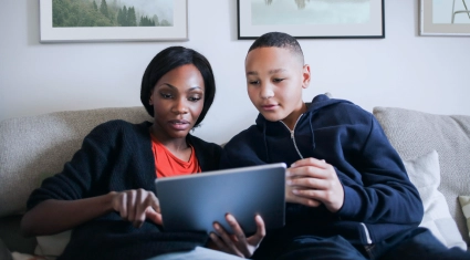 Femme et son fils devant leur tablette tactile